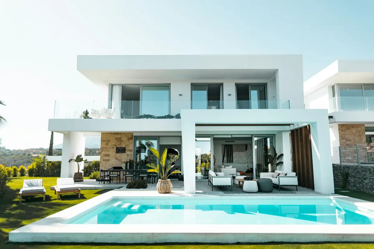 Contemporary white villa opening to a pool and landscaped garden — architectural inspiration