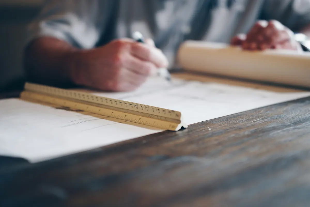 Architect developing a building plan at a drafting table